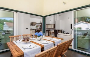 Enjoy meals with friends and family in this spacious dining area, featuring a large table and comfortable seating for six.