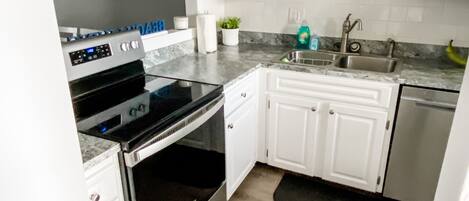 Fridge, microwave, coffee/tea maker, cookware/dishes/utensils