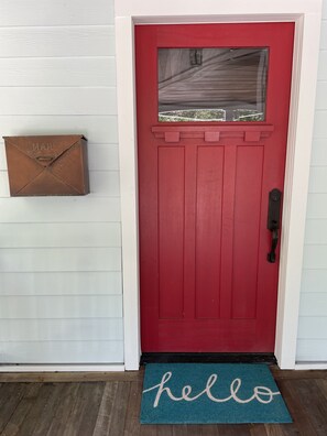 A red door with a mailbox and a 'hello' mat. - Updated Victorian Red Door Revival in Downton St Aug (Saint Augustine)