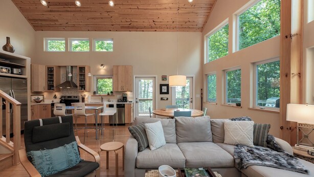 A spacious living area with a sofa, a dining table, and a kitchen in the background. - Moonlight Ridge*Sleeps 8*PetsoK*VIEW*Resort Access (Deep Gap)