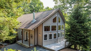 A two-story house with a covered porch and a chimney. - Moonlight Ridge*Sleeps 8*PetsoK*VIEW*Resort Access (Deep Gap)