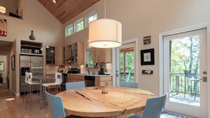A modern kitchen with a central island, built-in appliances, and a large window providing natural light. - Moonlight Ridge*Sleeps 8*PetsoK*VIEW*Resort Access (Deep Gap)