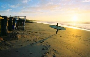 Guests can walk down to the beach from the property via a staircase, where they may enjoy the ocean views.