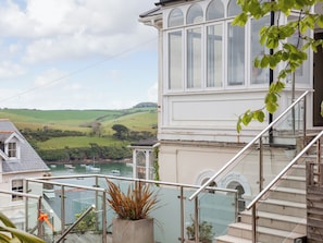 A coastal building with a view of the sea and hills. - 4 bedroom accommodation in Devon Road (Devon Road)