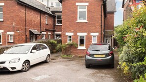 A residential area with two brick houses, one with a visible garage door and another with a visible window. - 1 bedroom accommodation in Mount Boone (Mount Boone)