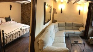 A bedroom with a bed, a sofa, and a coffee table. - La  Posada de Leza (Leza)