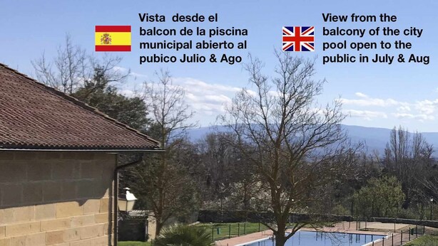 A view from a balcony overlooking a swimming pool, with a stone building and patio furniture visible. - La  Posada de Leza (Leza)