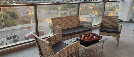 Relax on the balcony with wicker furniture and enjoy the view of the surrounding area.