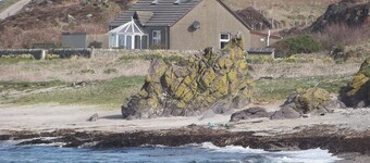 A detached cottage with views across to Gigha and the Paps of Jura.