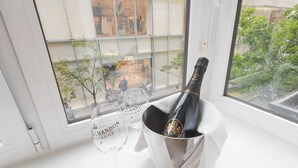 A bottle of champagne in a bucket on a windowsill with two glasses beside it. - CONCHA CITY CENTER, FREE PARKING! Top location. Air Conditioning !  (Donostia)