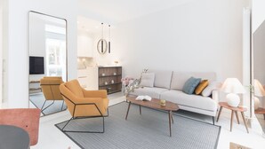 A modern living room with a sofa, armchair, coffee table, and a TV. - CONCHA CITY CENTER, FREE PARKING! Top location. Air Conditioning !  (Donostia)
