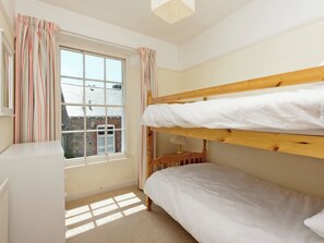 A bunk bed room with a window, a radiator, and a lamp. - 4 bedroom accommodation in Cliff Rd/Courtenay (Cliff Rd/Courtenay)