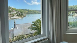 A view of a coastal town with buildings, a harbor, and boats. - 2 bedroom accommodation in Above Town (Above Town)