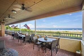 Outdoor dining - Beachfront 1BR Apollo condo with pool, WiFi, kitchen, and Gulf views. (Marco Island)