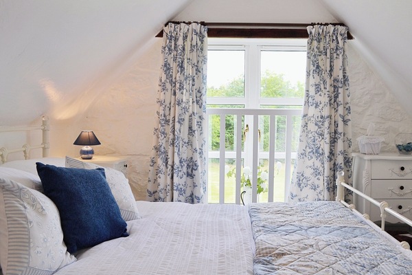 Spacious and romantic double bedroom with sloping ceiling | Woodside Cottage, Nether Bellandy, Glenrinnes, near Keith
