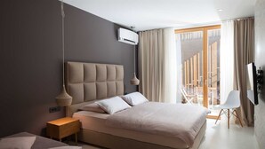 A modern bedroom with a large bed, bedside tables, a TV, and a balcony with curtains. - Awarded Design Villa Olea, Luxury Villa with heated pool & Seaview (Klimno (Krk))