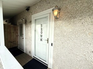 A white door with a frosted glass panel and the word 'BROWN' spelled out on it.