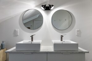 A bathroom with two white sinks, round mirrors, and a light fixture above. - Quiet house in Pau's historic district (Pau)