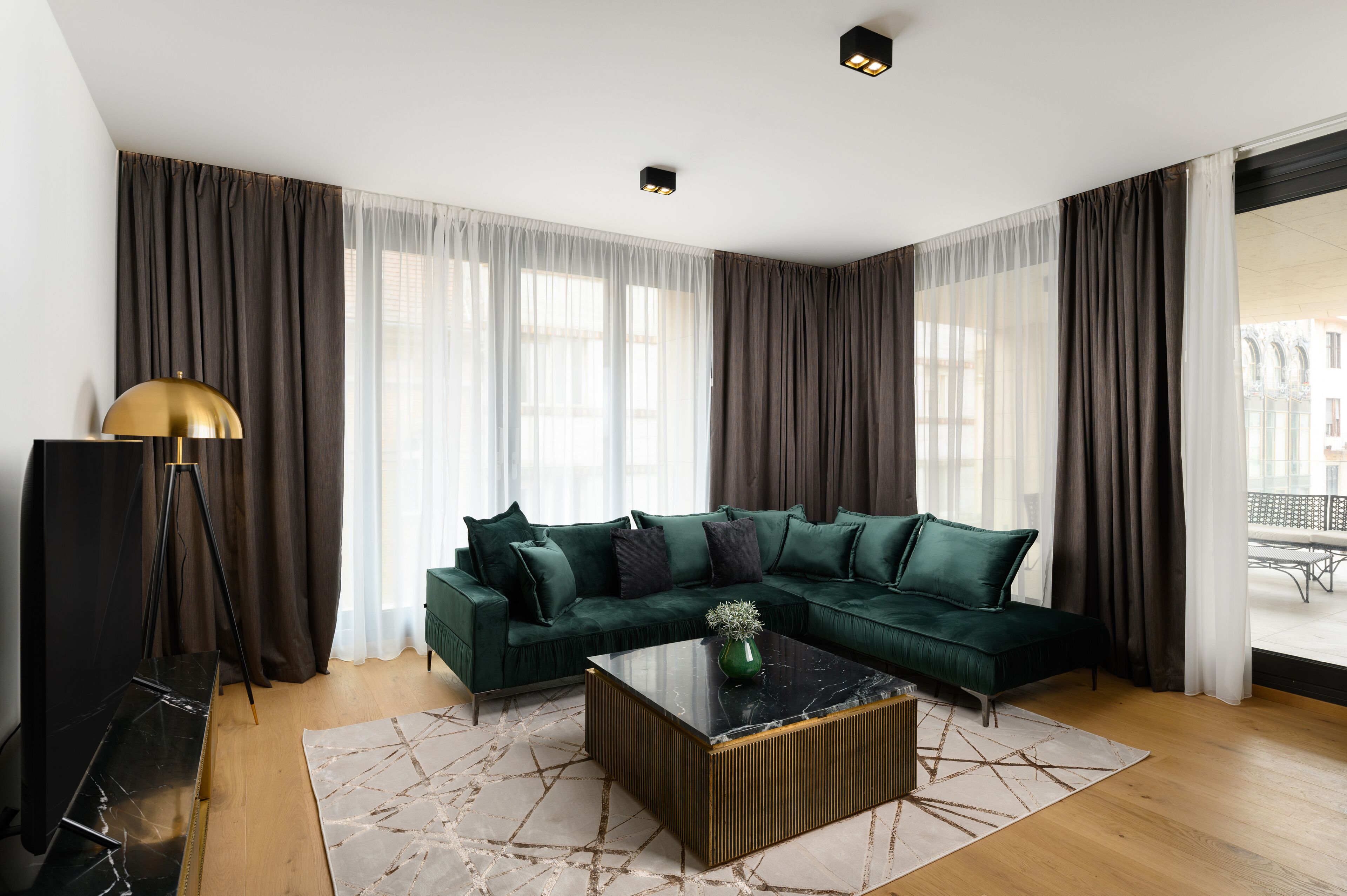 A modern living room with a sectional sofa, a coffee table, and a floor lamp.