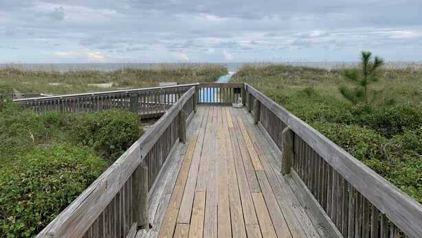 A wooden boardwalk leading to a beach with overcast skies. - Fall / Snow Bird Special• 6-Min Walk to  Beach • Pool, Tennis -Gated–Hilton Head (Hilton Head)