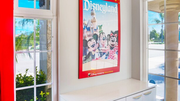 A poster of Disneyland with Mickey, Minnie, and Daisy on a white wall. - Hotel 414 Anaheim, Luxurious King Size Bed (Anaheim)