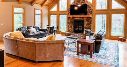 Spacious, family-friendly lodge on 10 wooded acres. Sleeps 20 with 5 bedrooms, stocked pond