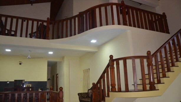 A spacious living area with a wooden staircase connecting two floors. - Villa Vinses In Hikkaduwa (Hikkaduwa)