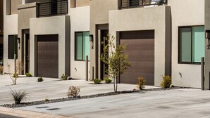 A modern multi-story residential building with balconies, large windows, and a clean, contemporary design. - Perfect Escape - Brand New St. George Townhome (St. George)