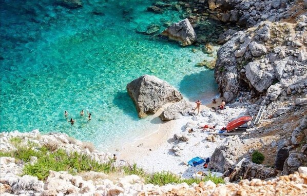 Enjoy swimming and sunbathing in the turquoise sea, with a tranquil atmosphere and opportunities for water activities.