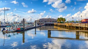 A marina with boats docked, a covered area, and a waterfront view.