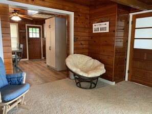 Relax in a cozy seating area with a plush chair and dining table.