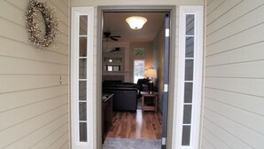 A doorway leading into a house with a kitchen visible inside. - Beautiful Home in Golf Course Community - 3 Bedroom plus Den (Meridian)