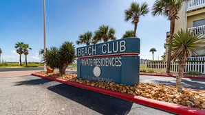 A sign for 'Beach Club Private Residences' at 14721 Whitecap Blvd. - Island Oasis! 1st floor! One block to the beach! (Corpus Christi)