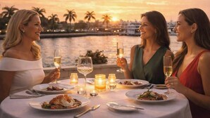 A table set for a meal with wine glasses, candles, and plates of food. - Modern home w/heated pool, BBQ & casita (West Palm Beach)