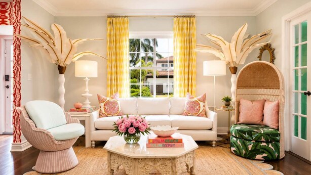 A living room with a white sofa, a round coffee table, a wicker chair, and a green patterned sofa. - Modern home w/heated pool, BBQ & casita (West Palm Beach)