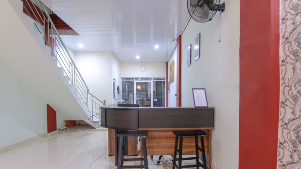A modern kitchen with a wooden countertop and two stools.