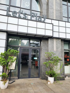 A building with a large sign reading "Let's Play" above the entrance.