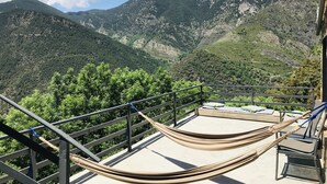 A hammock on a balcony with a mountain view. - Spacious house (sleeps 7) with incredible view HUT6007971 (Aubinyà)