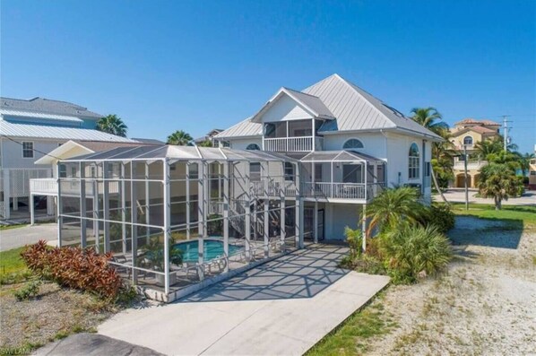 Enjoy an outdoor space with a pool and a spacious balcony overlooking a well-maintained lawn.
