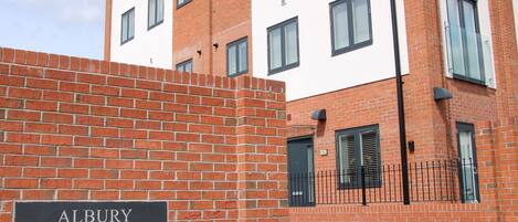 A brick wall with a sign reading "ALBURY PLACE".