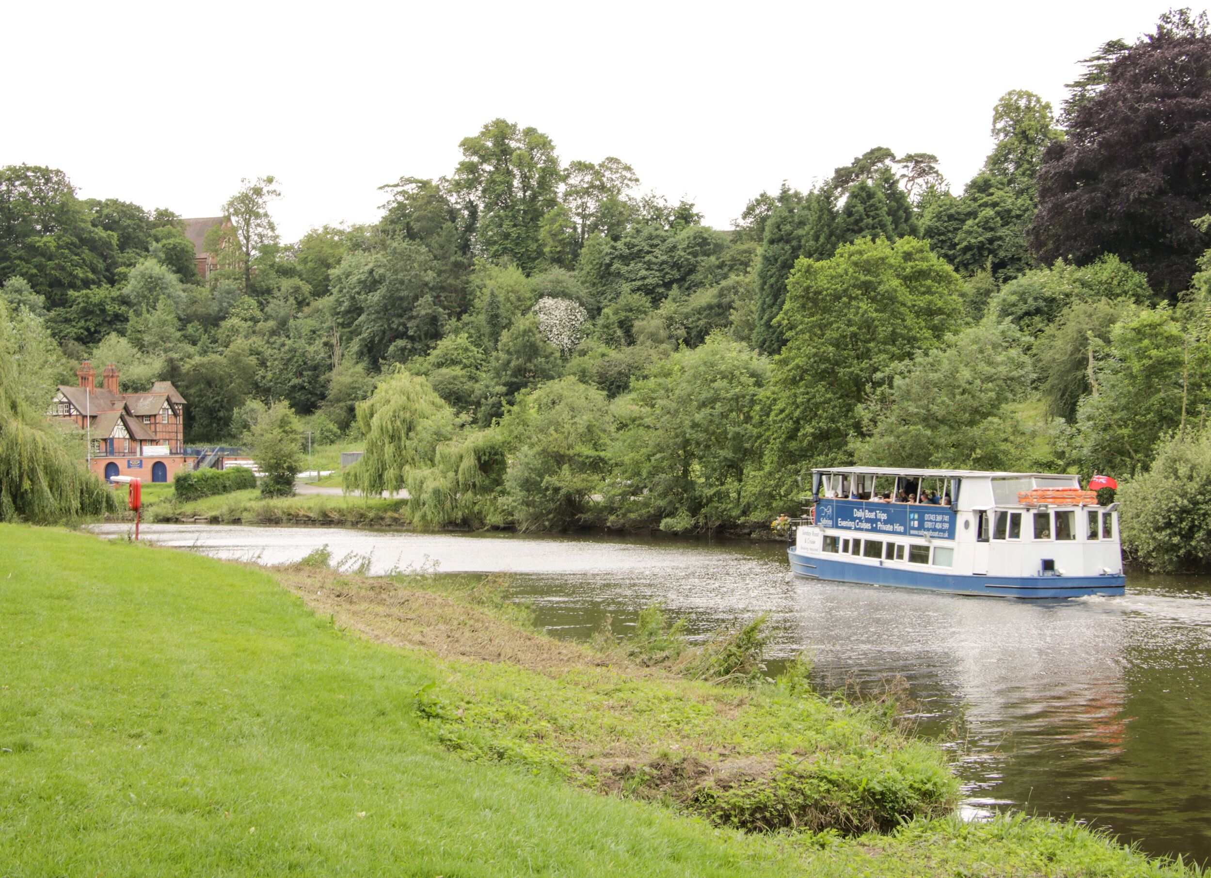 A river with a boat and a building in the background.