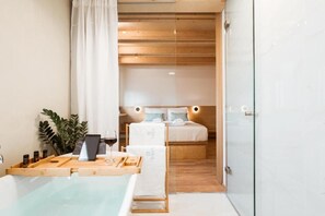 A modern bathroom with a glass shower enclosure, a wooden vanity, and a bathtub. - Thallos the Boutique (Chania)