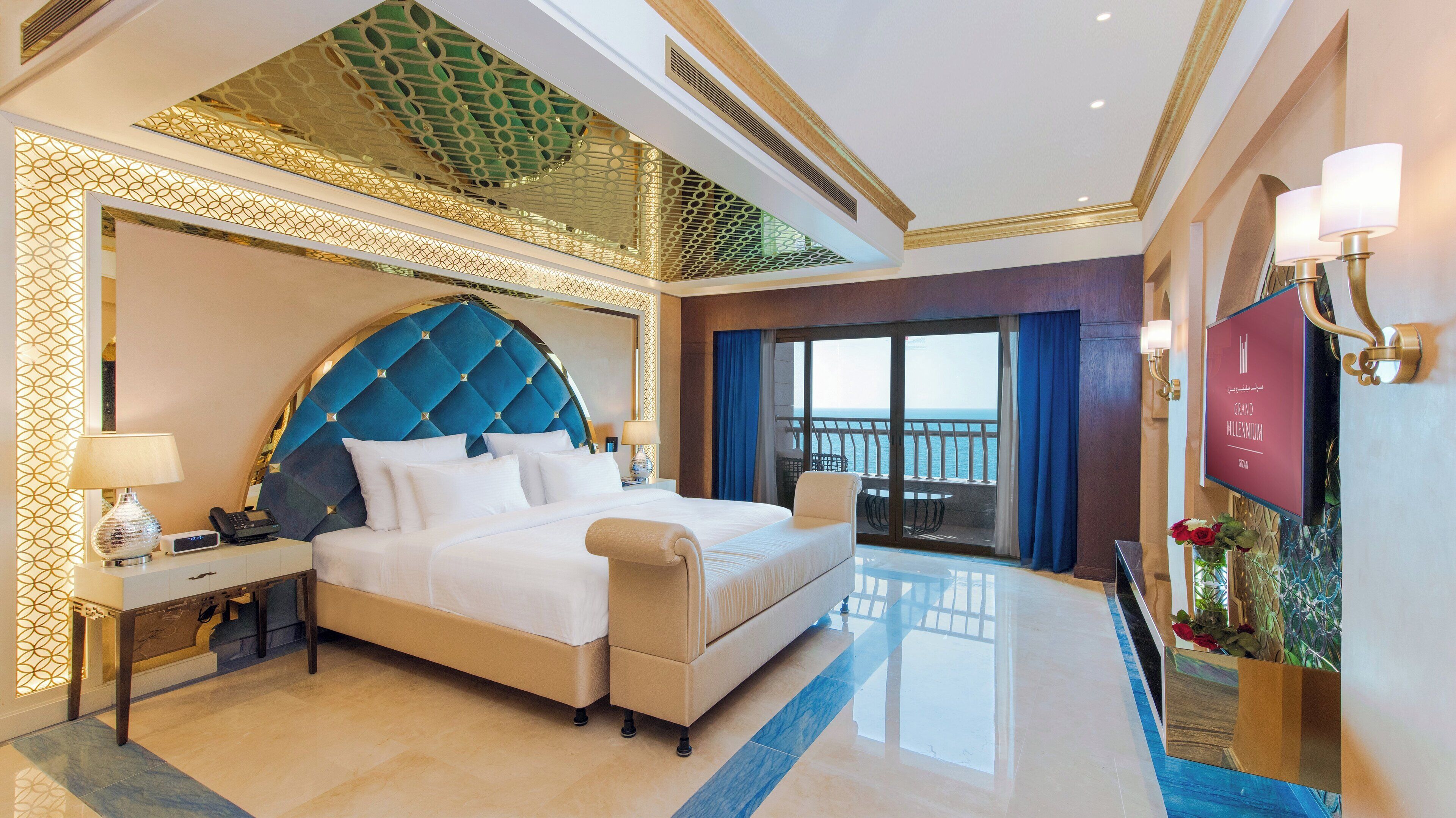 A luxurious hotel room with a large bed, a balcony with a view, and a modern design.