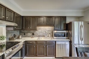 Fridge, microwave, coffee/tea maker, cookware/dishes/utensils