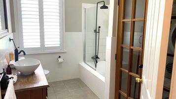 Bathtub, hair dryer, towels, shampoo