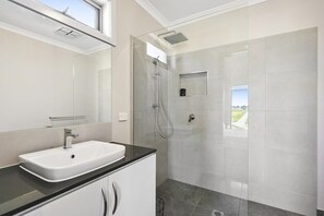 Bathtub, hair dryer, towels, shampoo