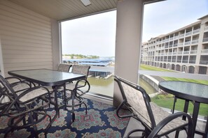 A balcony with a view of a water body and a hotel building. - Welcome to Paradise!Screened Patio-LANDS END 12 x 36 Boat slip  Sleeps 6-8
GRILL (Osage Beach)