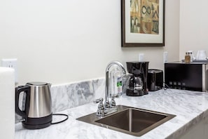 Fridge, microwave, coffee/tea maker, cookware/dishes/utensils