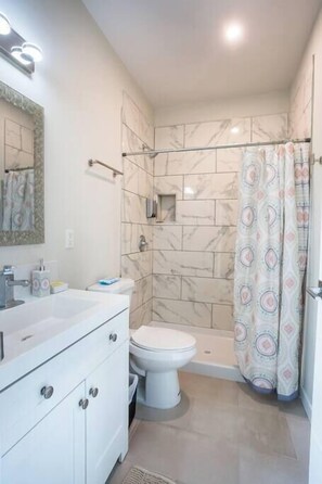 Shower, hair dryer, towels, shampoo