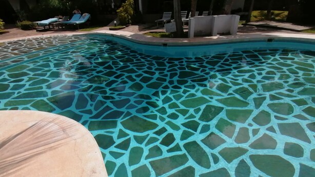 A swimming pool with a mosaic tile design. - Johari Villas (Malindi)